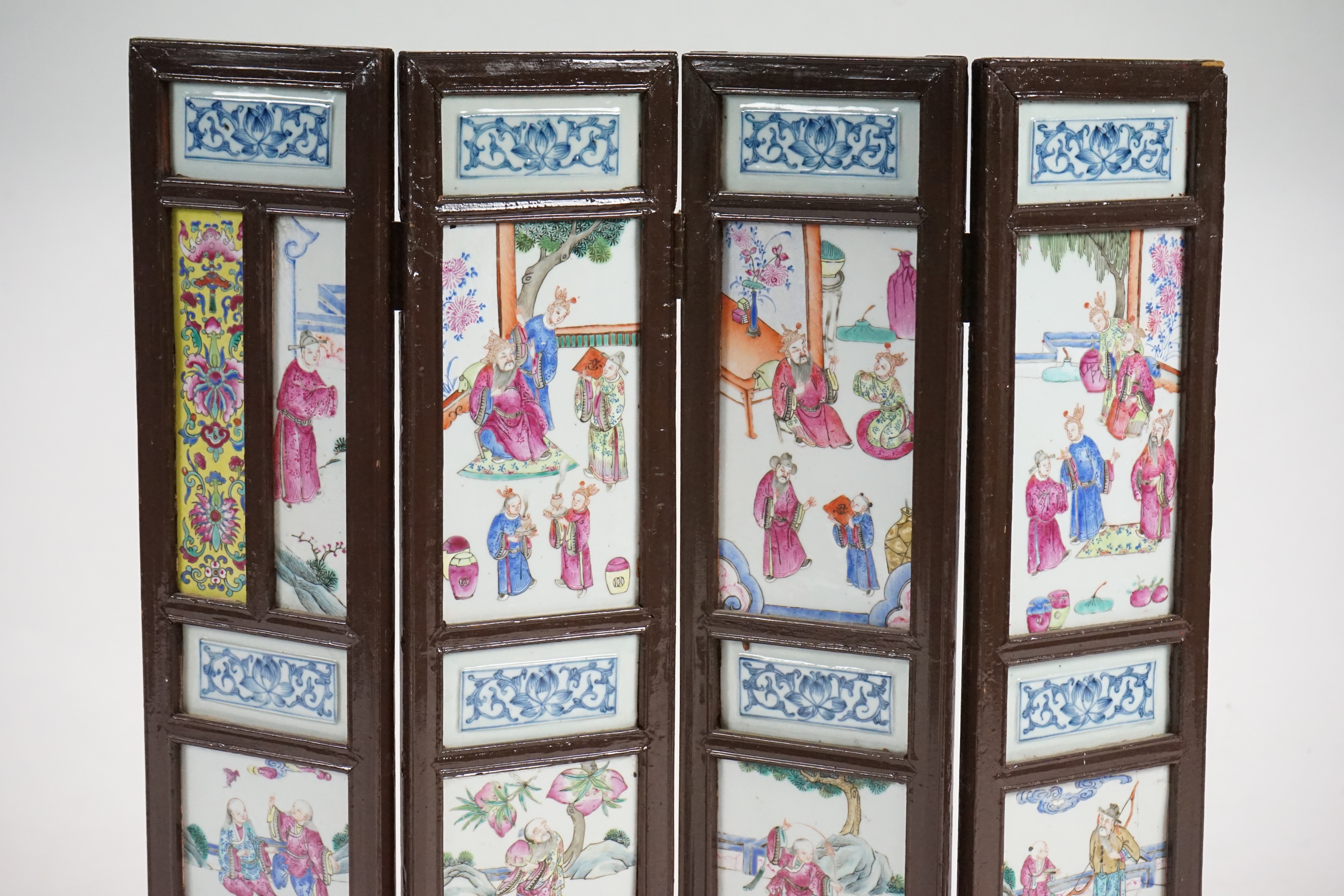 A Chinese wood framed and porcelain mounted low screen, late 19th century